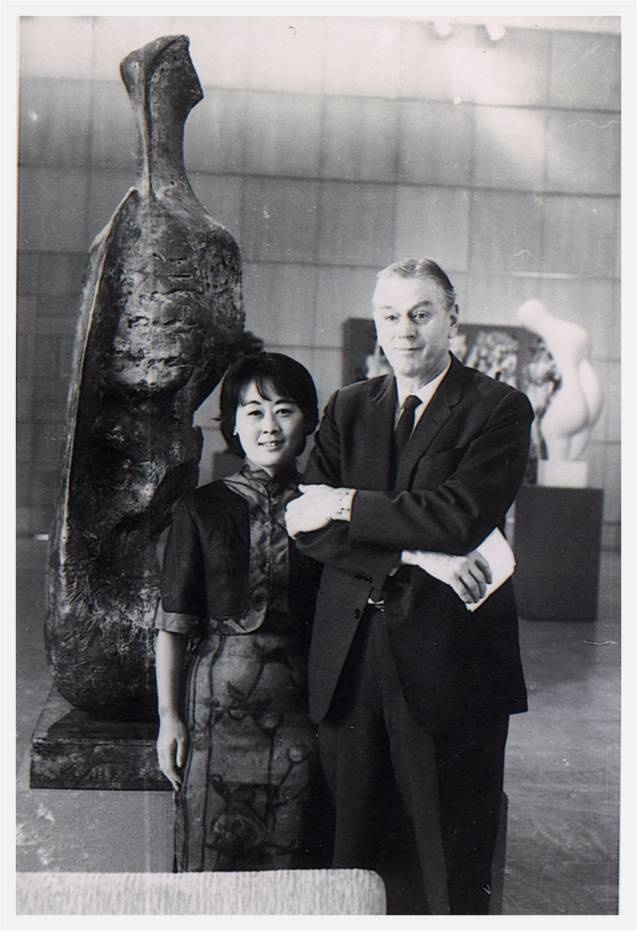 a black and white photo of a couple at a museum