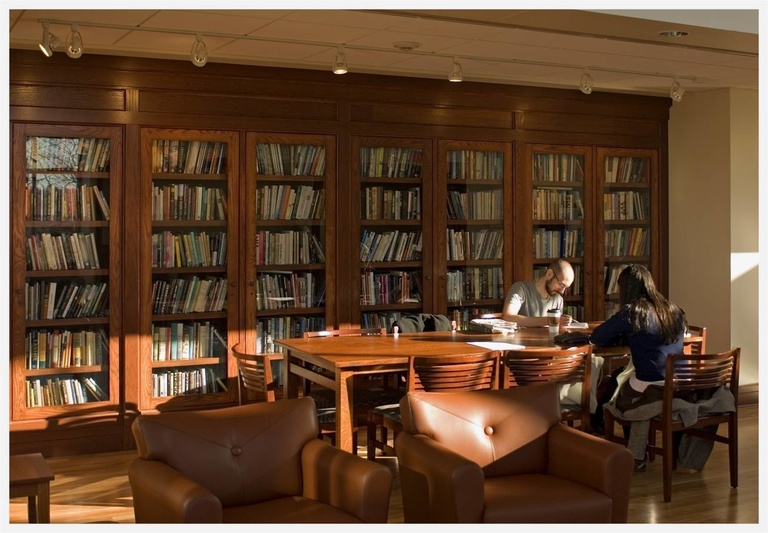 two students in a large well lit library